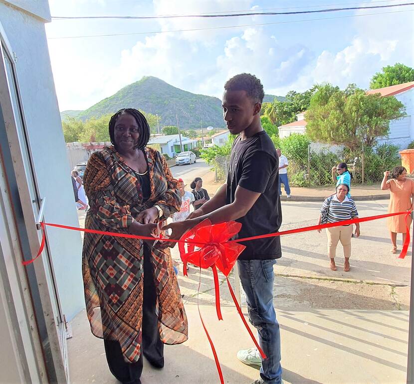Government Commissioner Alida Francis and Keisy Lopez cutting the ribbon at the Golden Rock Training Center in Golden Rock village.